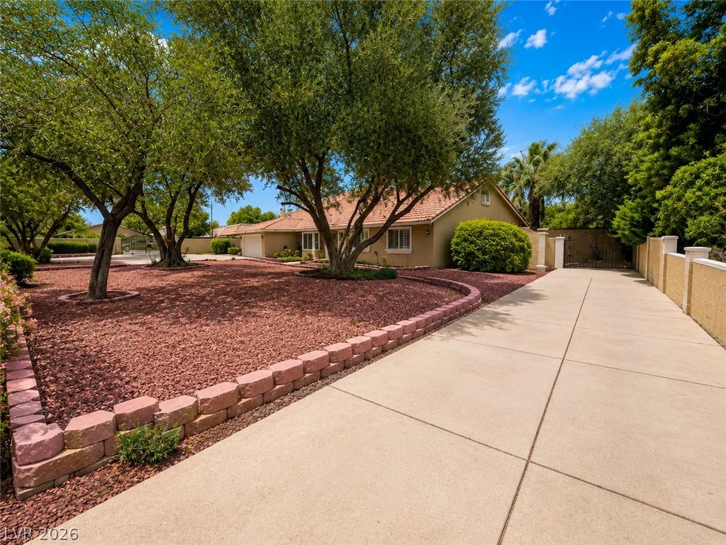 3010 East Viking Road Las Vegas, NV 89121 - Photo 3 of 48 A long paved driveway leads to a private, charming residence with mature shade trees.
