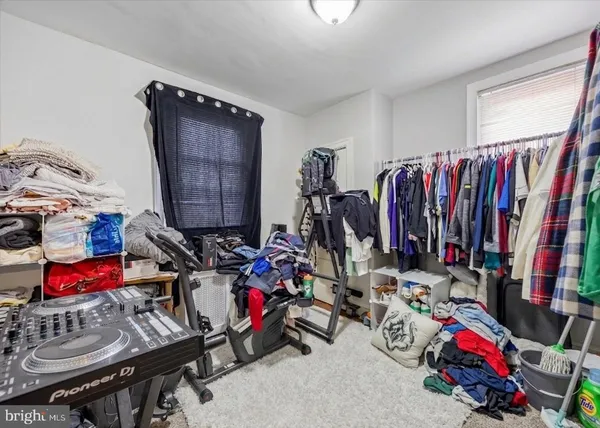a view of walk in closet with clothes