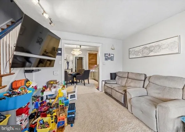 a living room with lots of baby furniture