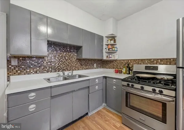 a kitchen with a sink stove and cabinets