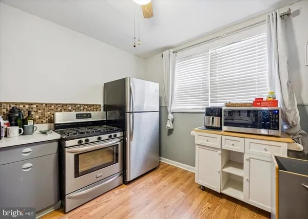 a kitchen with a stove a sink and a refrigerator