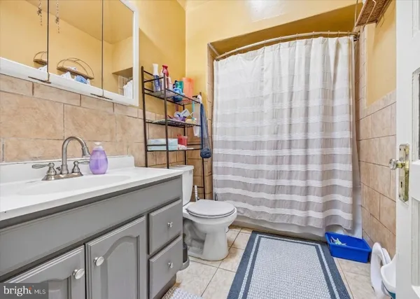 a bathroom with a sink a toilet and shower curtain