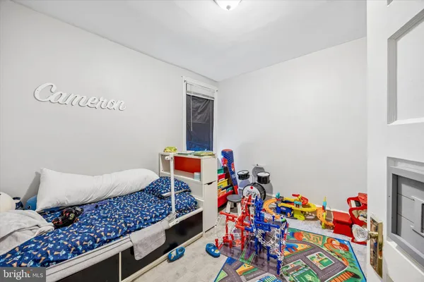 a bed room with a bed and a dresser