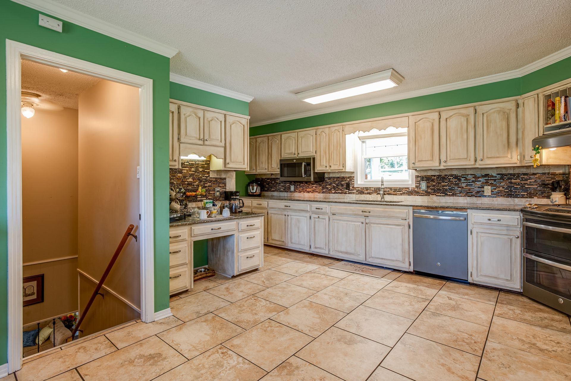 2743 Mouse Tail Road Parsons, TN 38363 - Photo 11 of 79 a kitchen with stainless steel appliances granite countertop a stove sink and cabinets