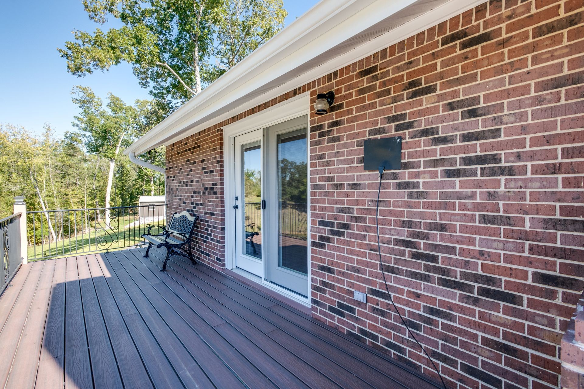 2743 Mouse Tail Road Parsons, TN 38363 - Photo 53 of 79 a brick building with a bench and a floor to ceiling window