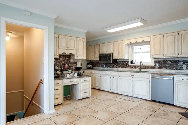 a view of a livingroom with a furniture and floor to ceiling window