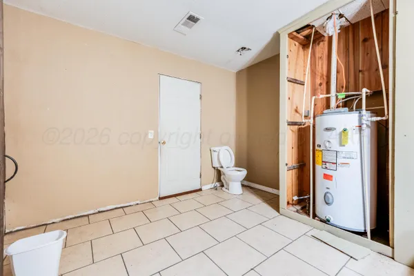a spacious bathroom with a shower and a toilet
