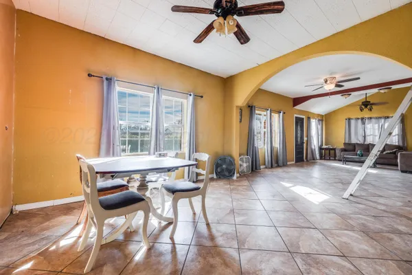a view of a dining room with furniture and a window