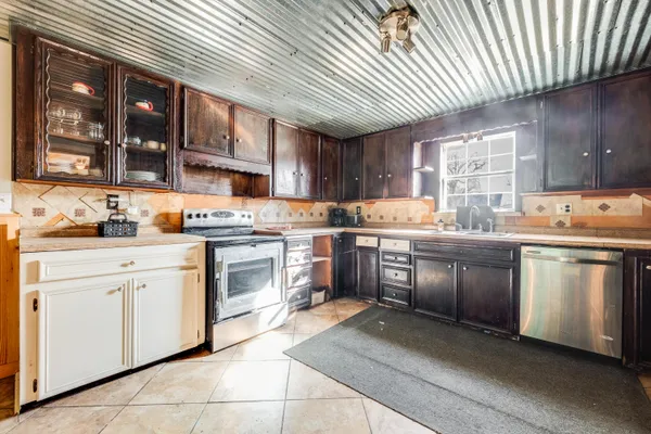 a kitchen with stainless steel appliances granite countertop a stove sink and cabinets