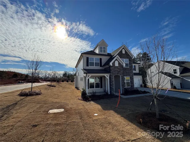 a view of a hallway with wooden floor and chandelier
