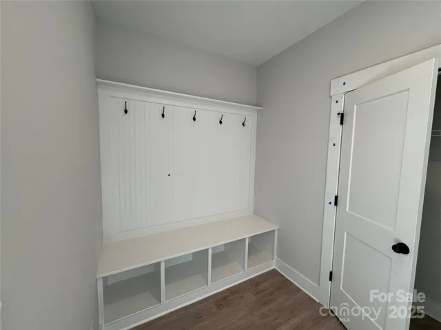 a kitchen with white cabinets and appliances