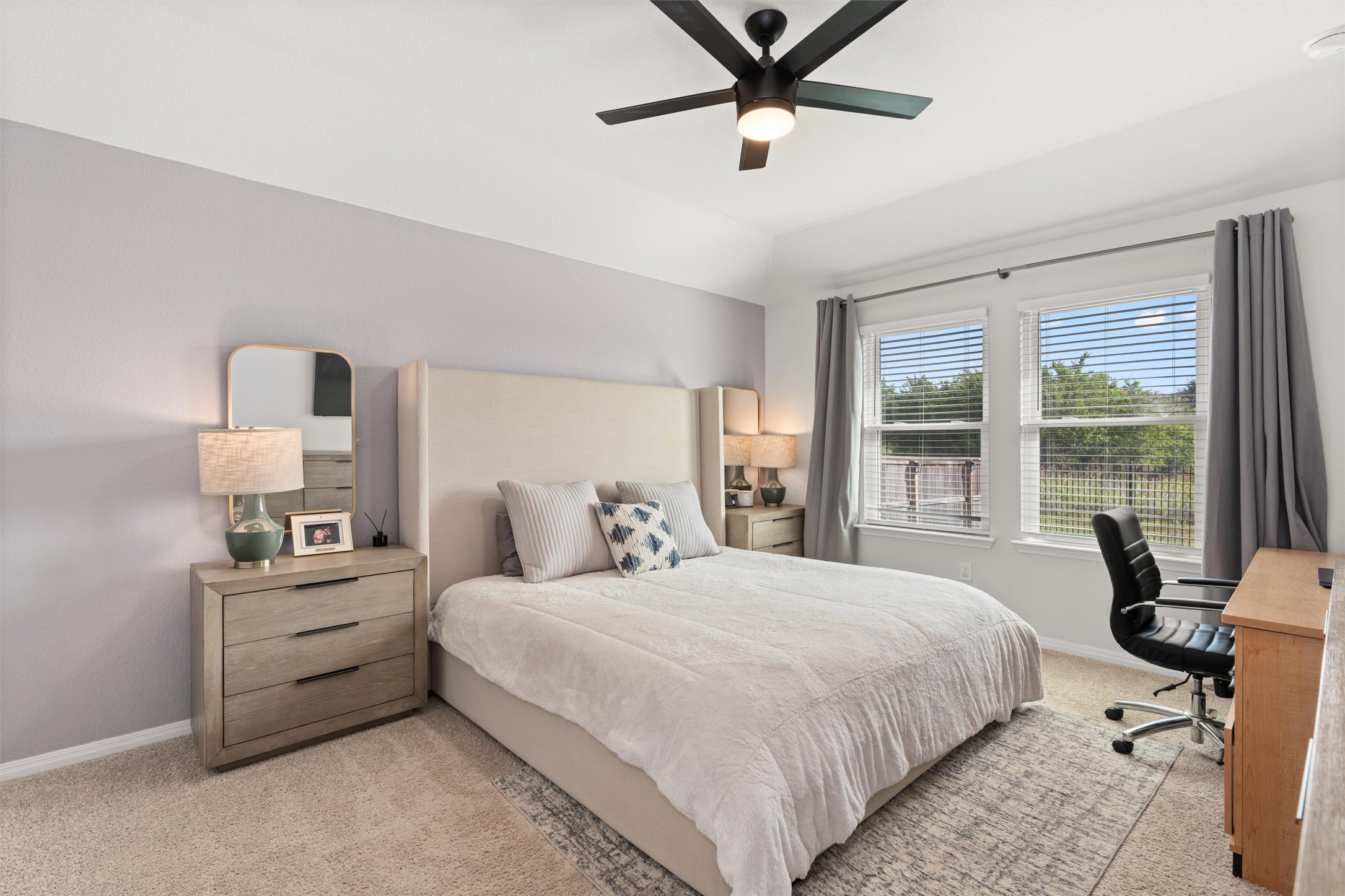19912 Abigail Fillmore Road Manor, TX 78653 - Photo 12 of 31 Naturally illuminated bedroom with plush carpet flooring and a ceiling fan for optimal comfort.