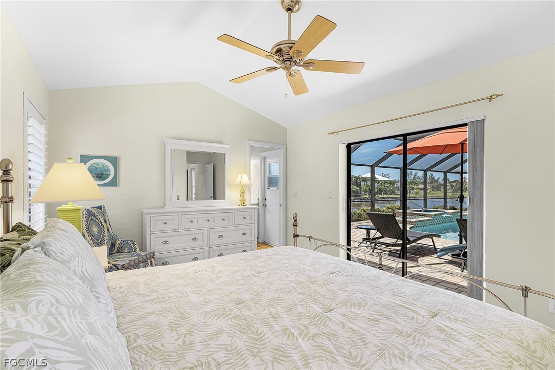 7747 Grande Pine Road Bokeelia, FL 33922 - Photo 28 of 45 a bedroom with a bed and glass windows