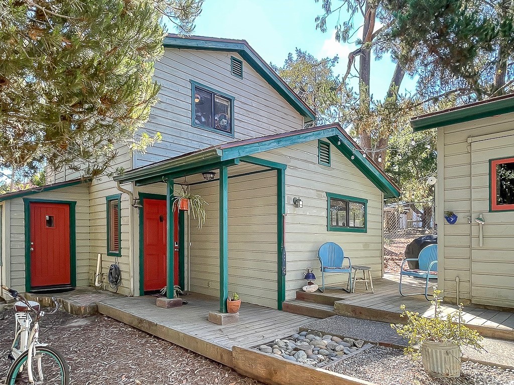 a backyard of a house with barbeque oven table and chairs