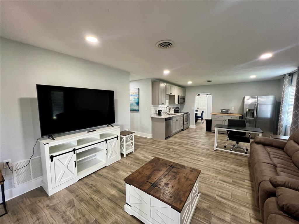 112 Rose Street Venice, FL 34293 - Photo 11 of 33 a living room with furniture and a flat screen tv