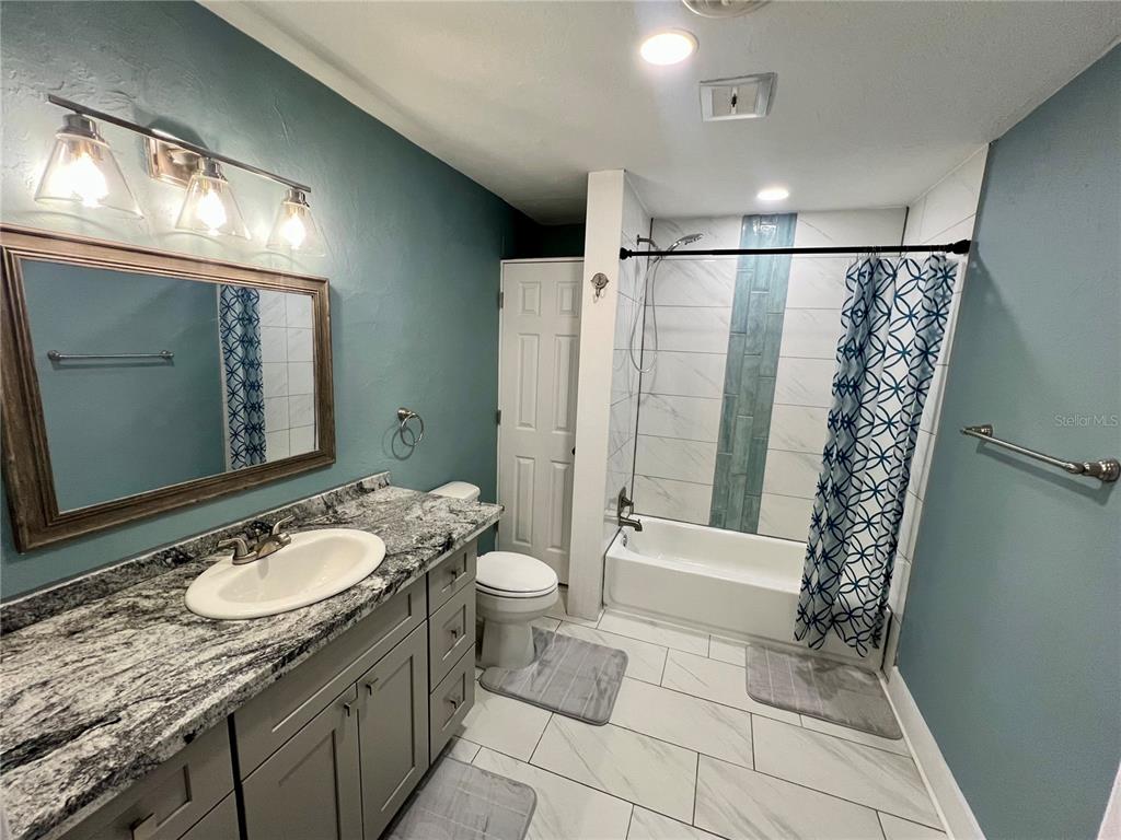 112 Rose Street Venice, FL 34293 - Photo 13 of 33 a bathroom with a granite countertop sink toilet and shower