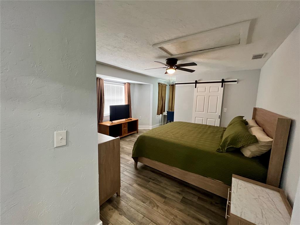 112 Rose Street Venice, FL 34293 - Photo 15 of 33 a bedroom with a bed and a mirror
