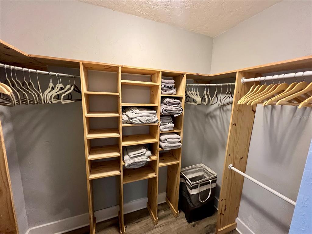 112 Rose Street Venice, FL 34293 - Photo 19 of 33 a view of walk in closet with clothes and shoes
