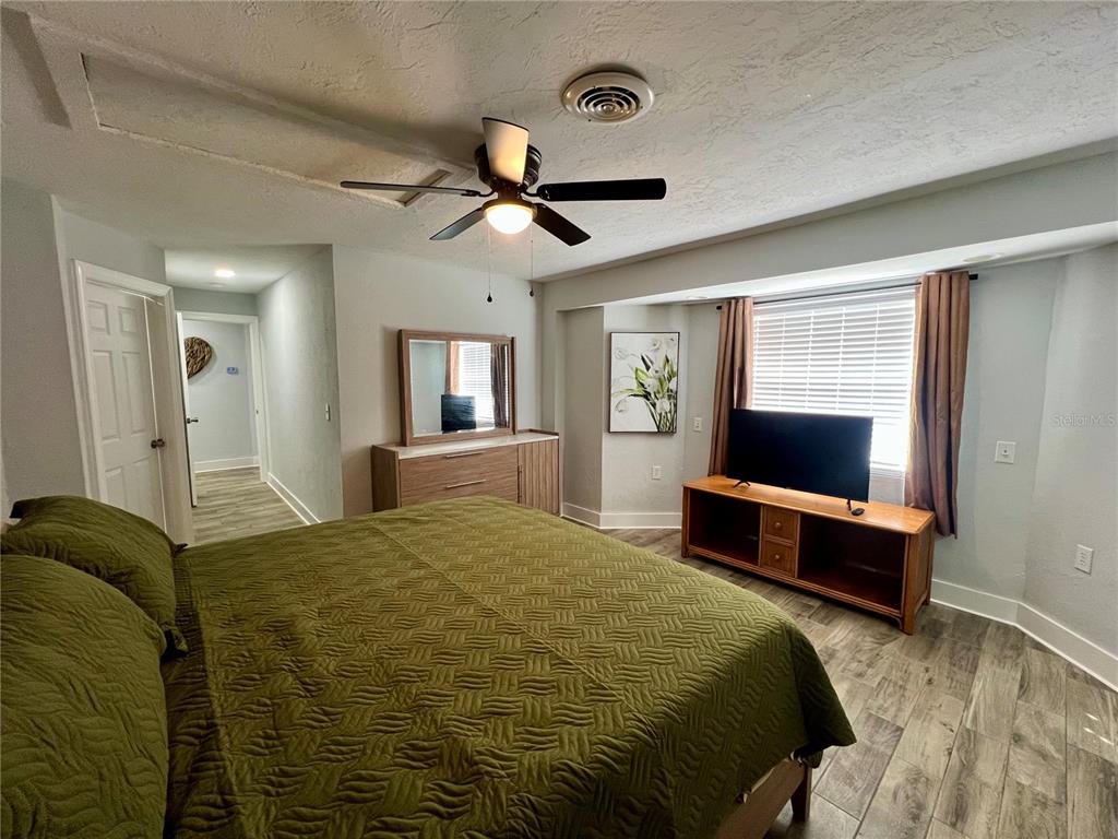 112 Rose Street Venice, FL 34293 - Photo 20 of 33 a bedroom with a bed and a dresser in it