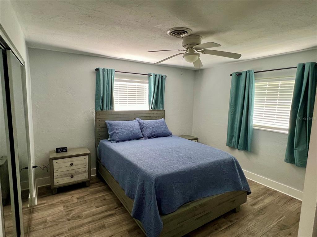 112 Rose Street Venice, FL 34293 - Photo 24 of 33 a bedroom with a bed and a chandelier