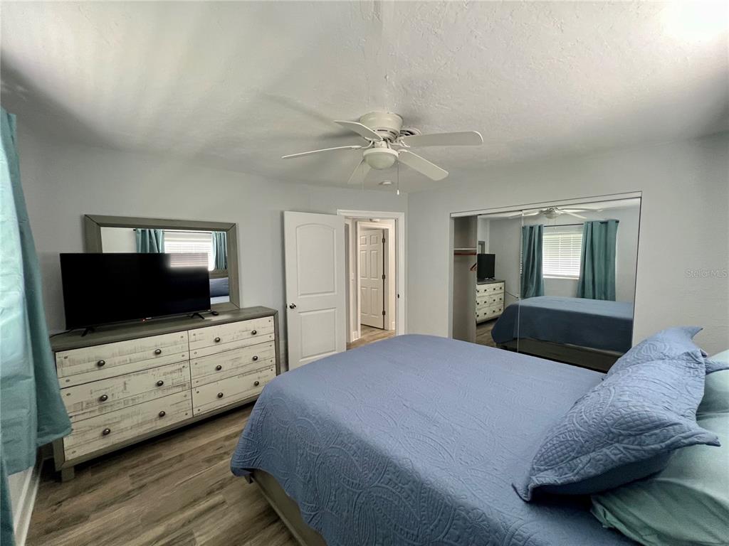 112 Rose Street Venice, FL 34293 - Photo 25 of 33 a bedroom with a bed and a flat screen tv