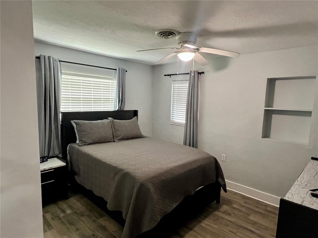112 Rose Street Venice, FL 34293 - Photo 26 of 33 a bedroom with a bed and a ceiling fan