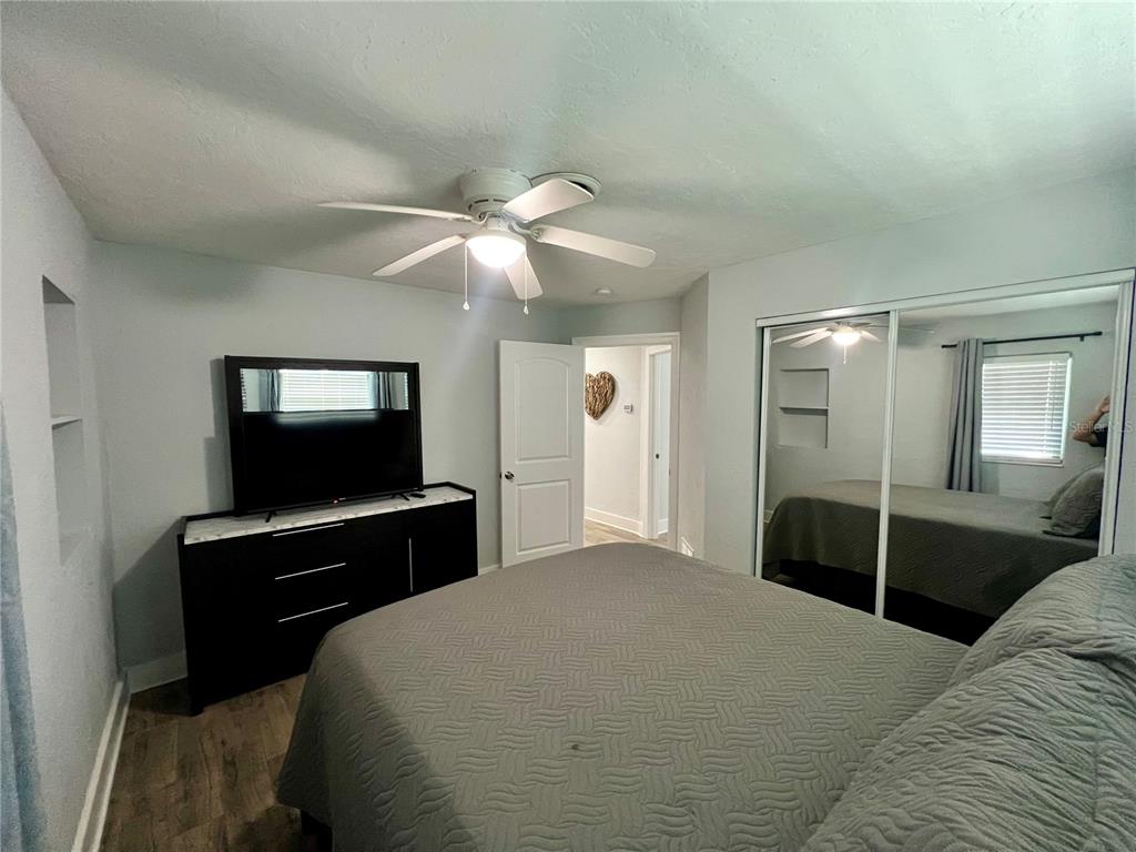 112 Rose Street Venice, FL 34293 - Photo 27 of 33 a bedroom with a bed and a flat tv screen on dresser