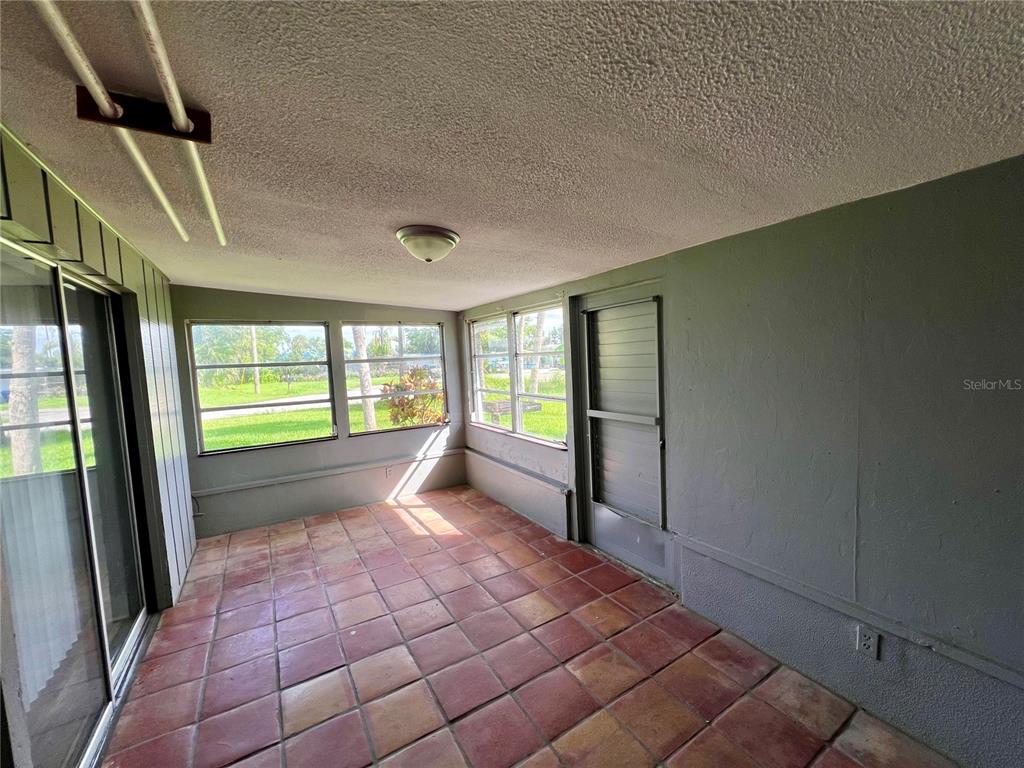 112 Rose Street Venice, FL 34293 - Photo 28 of 33 a view of empty room with wooden floor and fan