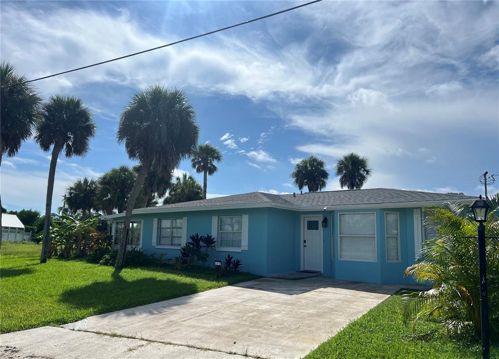 112 Rose Street Venice, FL 34293 - Photo 3 of 33 a front view of a house with a garden and plants