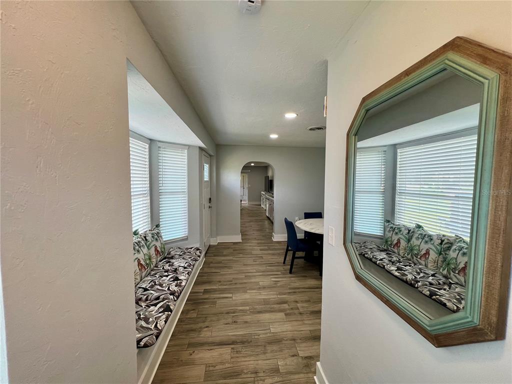 112 Rose Street Venice, FL 34293 - Photo 4 of 33 a hallway with beautiful frames and flower vase