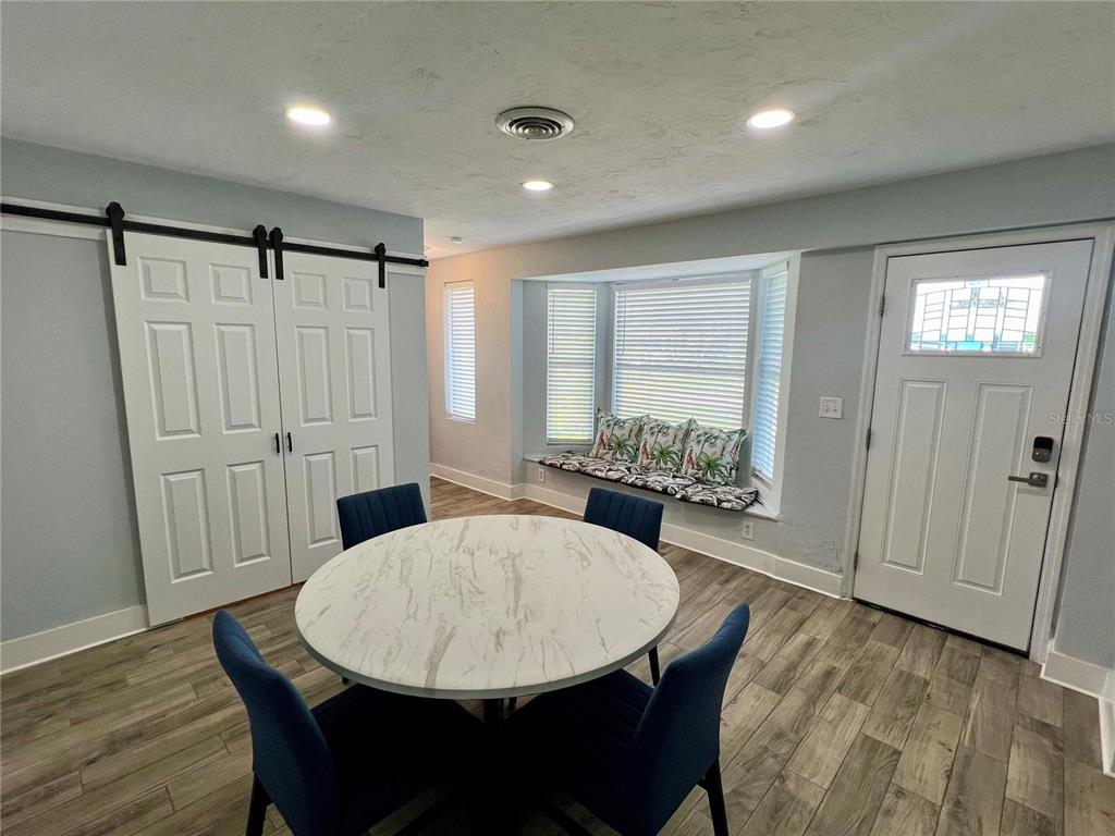 112 Rose Street Venice, FL 34293 - Photo 6 of 33 a view of a dining room with furniture window and wooden floor