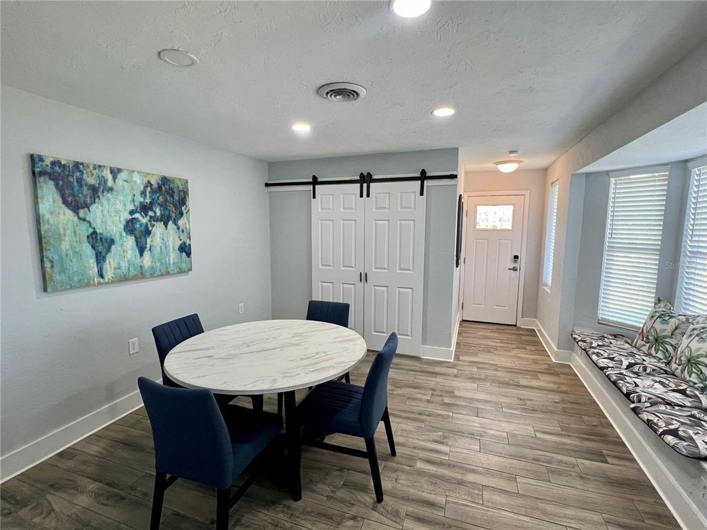 112 Rose Street Venice, FL 34293 - Photo 7 of 33 a view of a dining room with furniture window and wooden floor