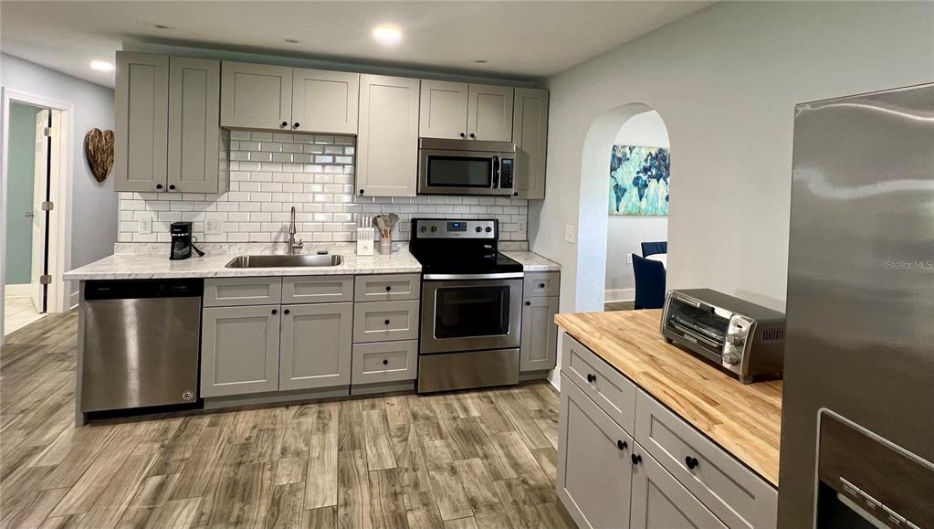 112 Rose Street Venice, FL 34293 - Photo 9 of 33 a kitchen with a sink stove and refrigerator