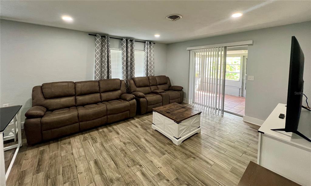 112 Rose Street Venice, FL 34293 - Photo 10 of 33 a living room with furniture and a flat screen tv