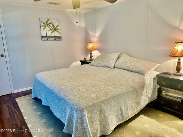 a bed sitting in a bedroom next to a lamp