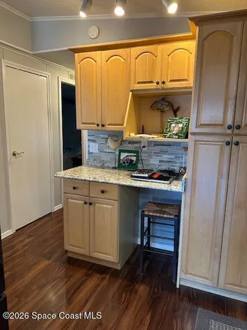 a room with wooden floor and furniture