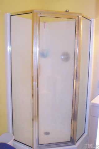 151 Granite Drive Roxboro, NC 27574 - Photo 8 of 12 a bathroom with a glass shower door and a sink