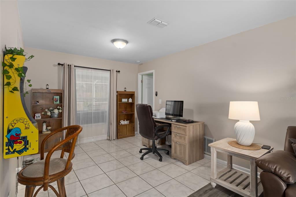 6101 County Line Road Spring Hill, FL 34606 - Photo 11 of 40 a view of a workspace with furniture and a lamp