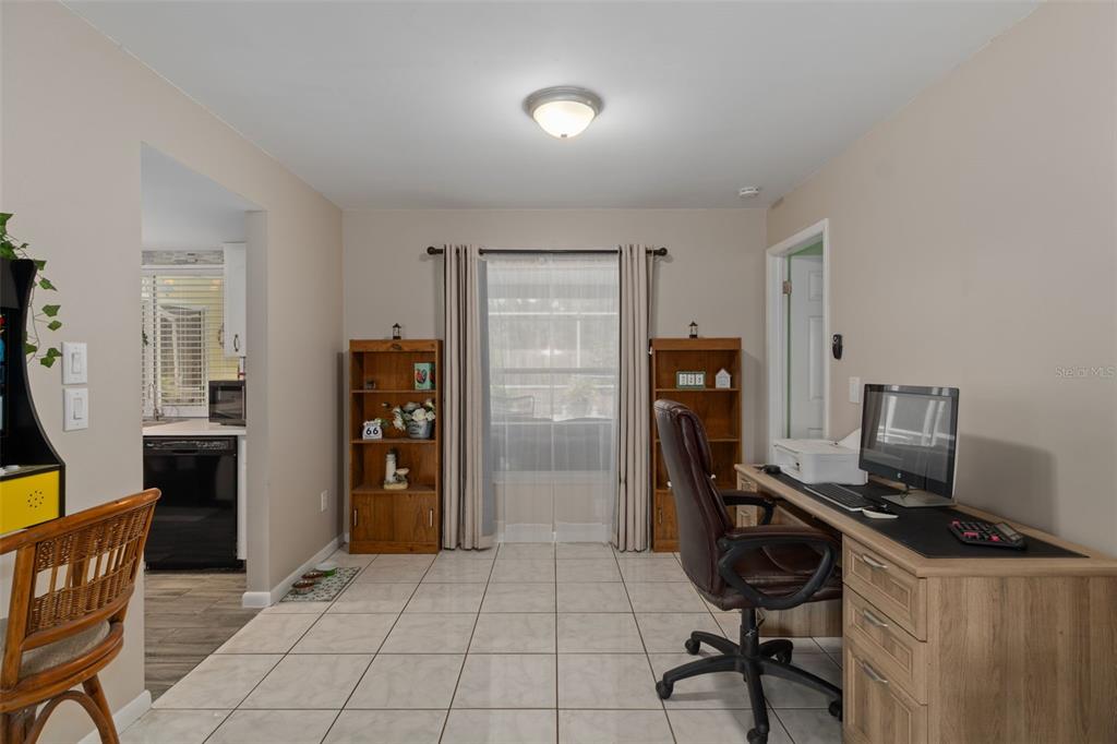6101 County Line Road Spring Hill, FL 34606 - Photo 12 of 40 a view of a workspace with furniture and gym equipment