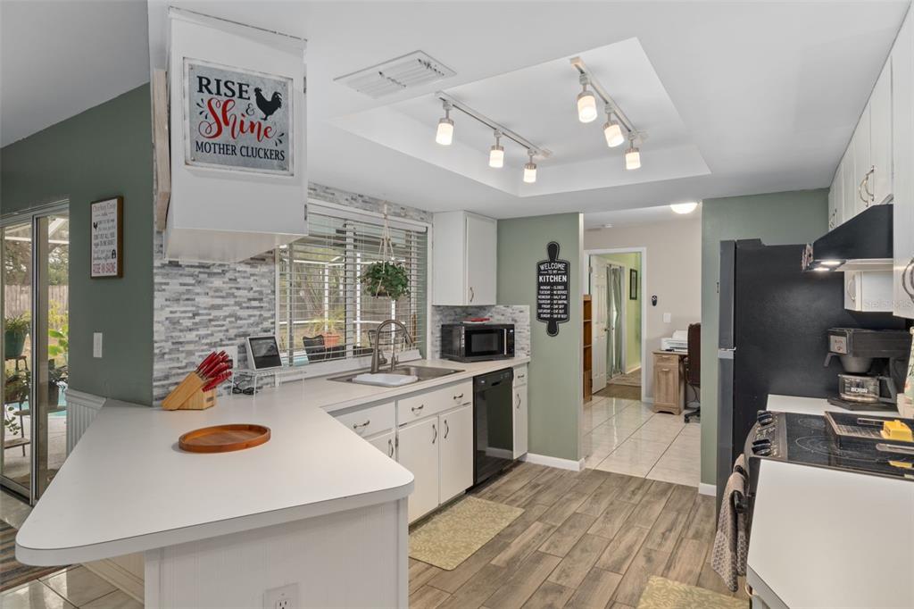 6101 County Line Road Spring Hill, FL 34606 - Photo 16 of 40 a large kitchen with a table chairs refrigerator and cabinets