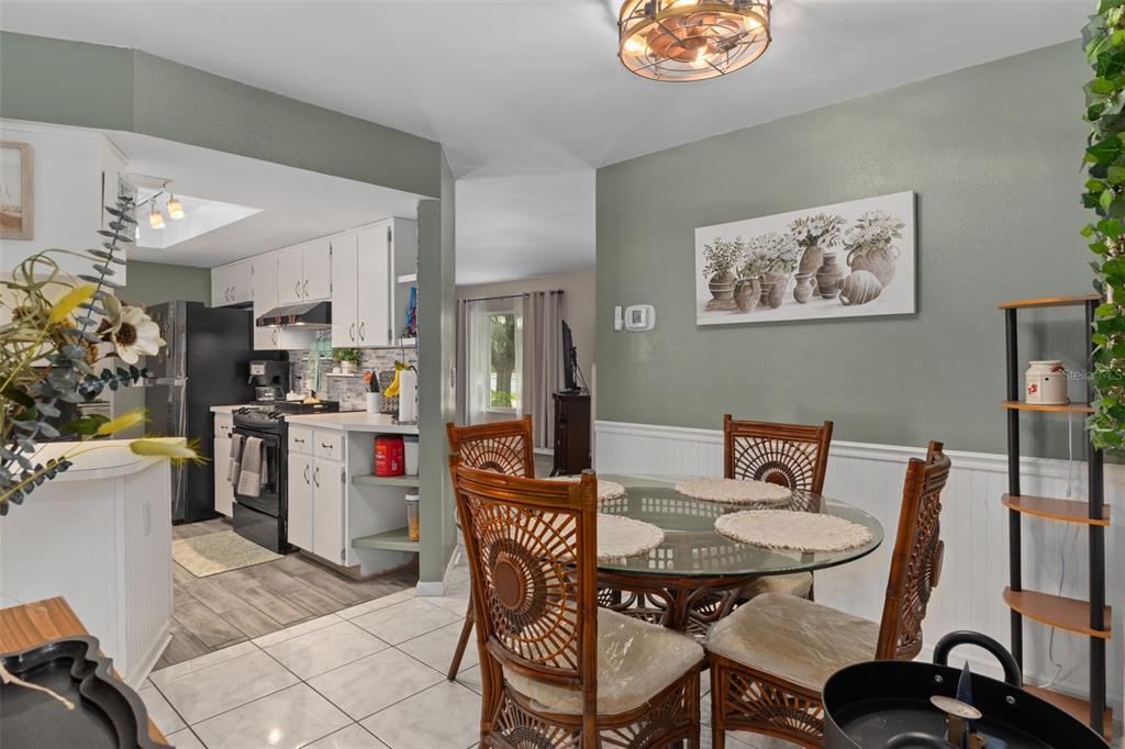 6101 County Line Road Spring Hill, FL 34606 - Photo 18 of 40 a view of a dining room with furniture and a chandelier