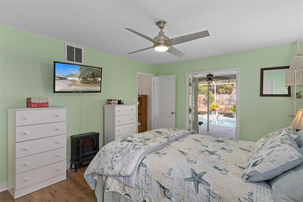 6101 County Line Road Spring Hill, FL 34606 - Photo 21 of 40 a bedroom with a bed and a chandelier