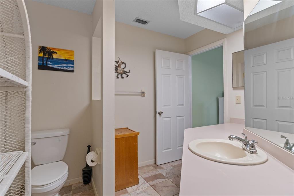 6101 County Line Road Spring Hill, FL 34606 - Photo 23 of 40 a bathroom with a toilet sink vanity granite and mirror