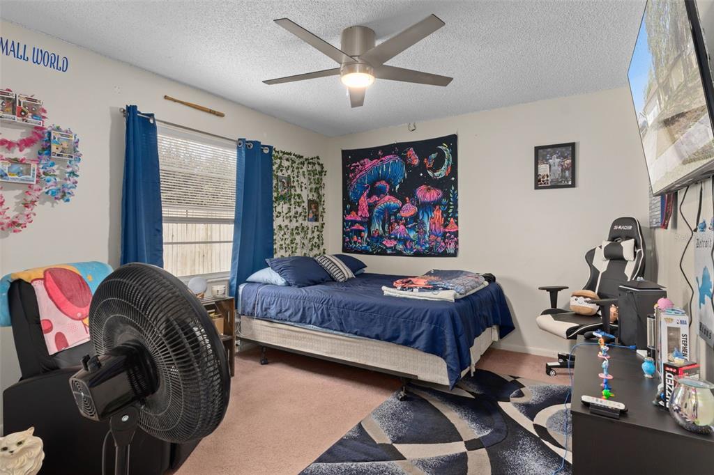 6101 County Line Road Spring Hill, FL 34606 - Photo 24 of 40 a bedroom with a bed and wooden floor