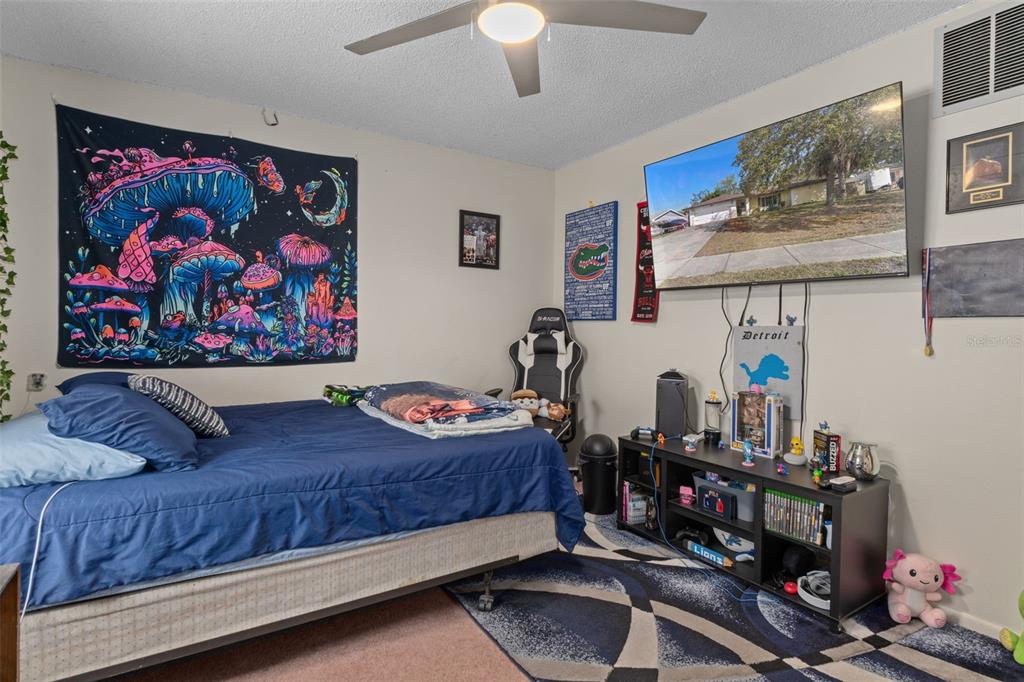 6101 County Line Road Spring Hill, FL 34606 - Photo 25 of 40 a bedroom with furniture and wooden floor