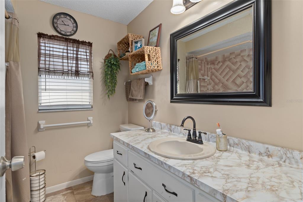 6101 County Line Road Spring Hill, FL 34606 - Photo 26 of 40 a bathroom with a sink and a mirror
