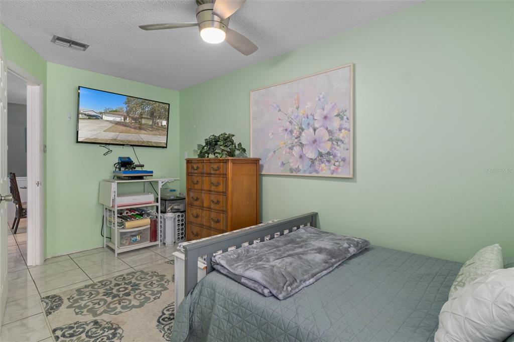 6101 County Line Road Spring Hill, FL 34606 - Photo 31 of 40 a bedroom with a bed and cabinets