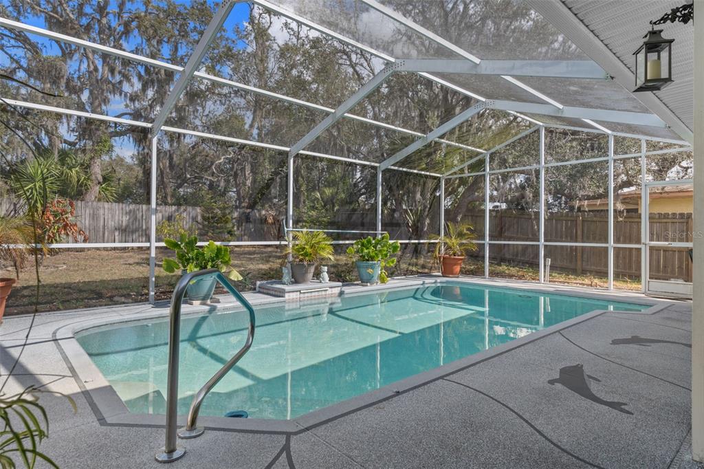 6101 County Line Road Spring Hill, FL 34606 - Photo 36 of 40 a view of a backyard with swimming pool and sitting area