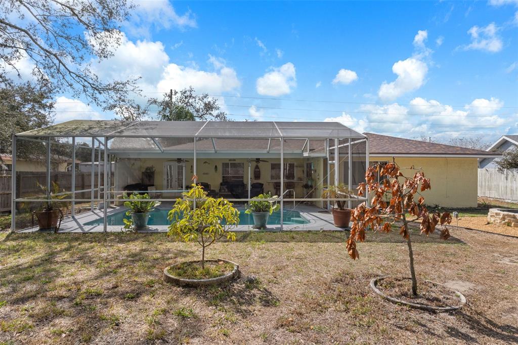 6101 County Line Road Spring Hill, FL 34606 - Photo 38 of 40 a view of a house with backyard porch and furniture