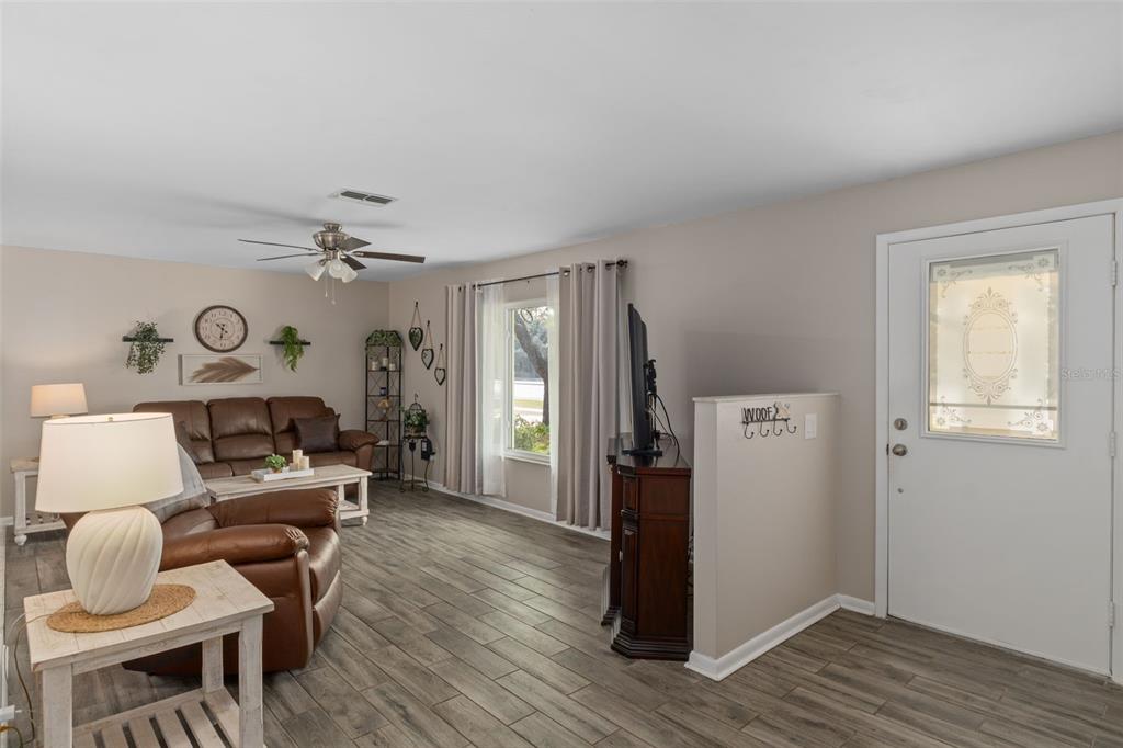 6101 County Line Road Spring Hill, FL 34606 - Photo 8 of 40 a living room with furniture and a wooden floor